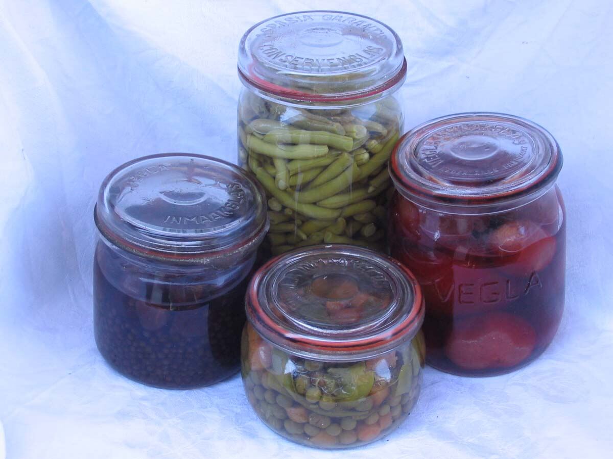 Glass jars of home-preserved vegetables and fruit