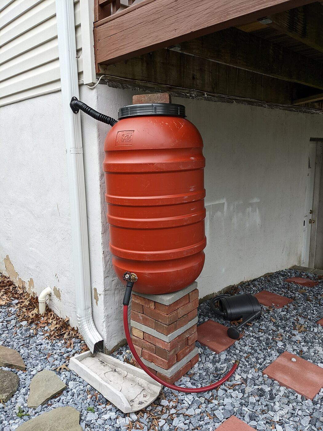Rain barrel collecting water from a downspout