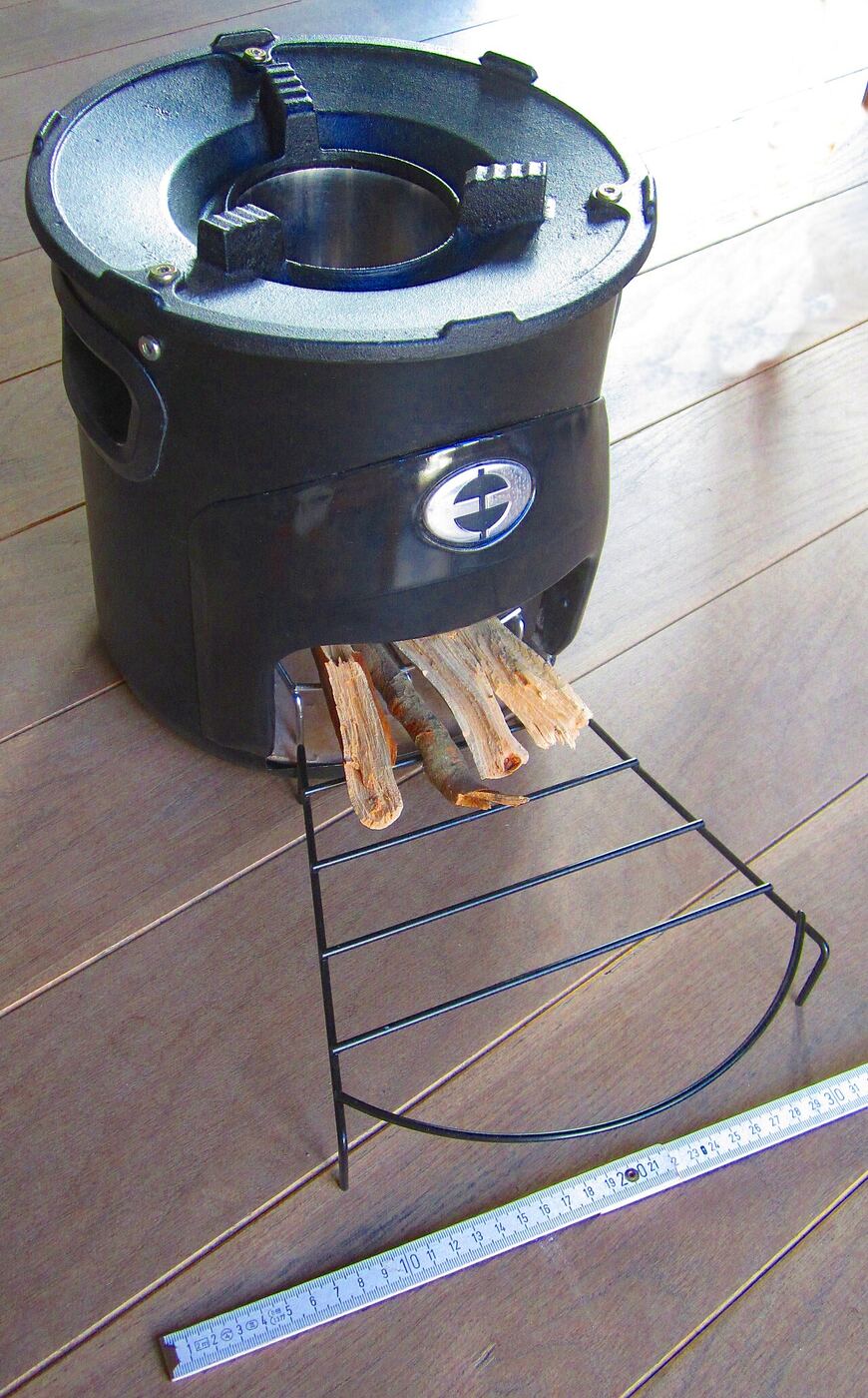 Small metal rocket stove burning sticks